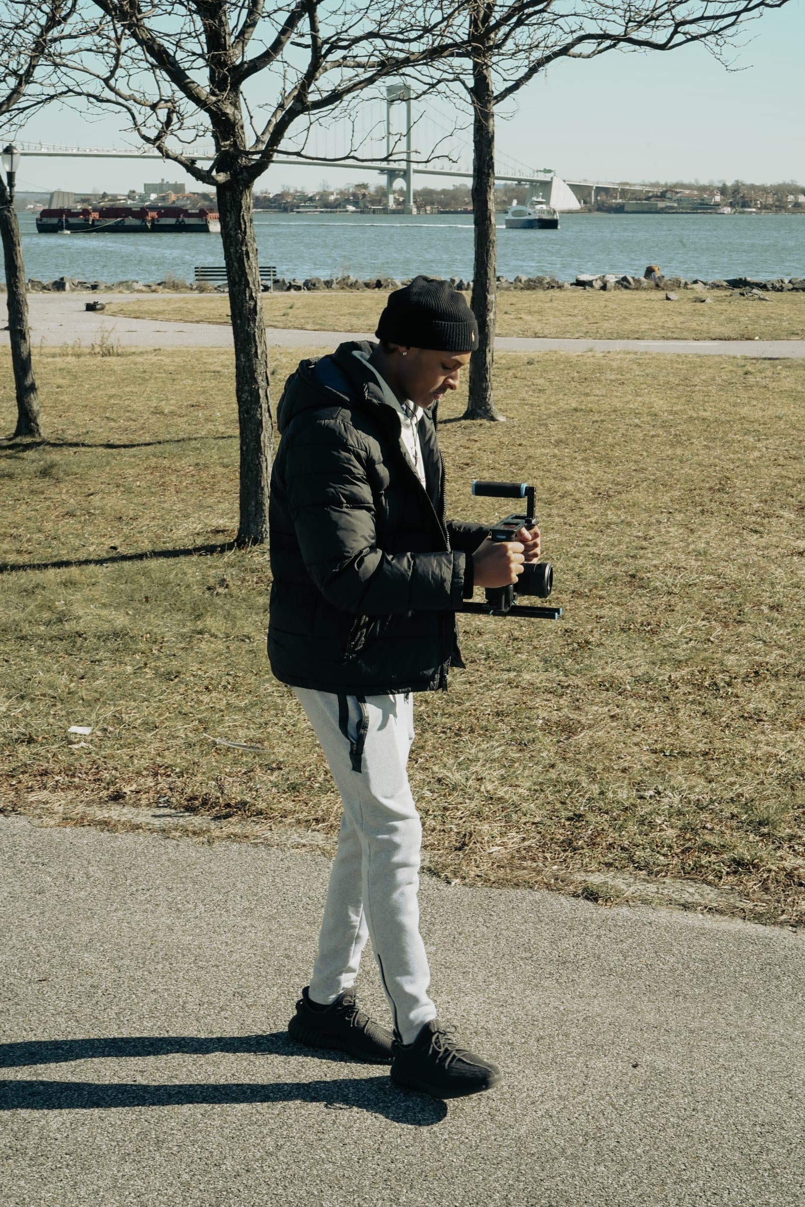 Alijah filming with a gimbal by the water